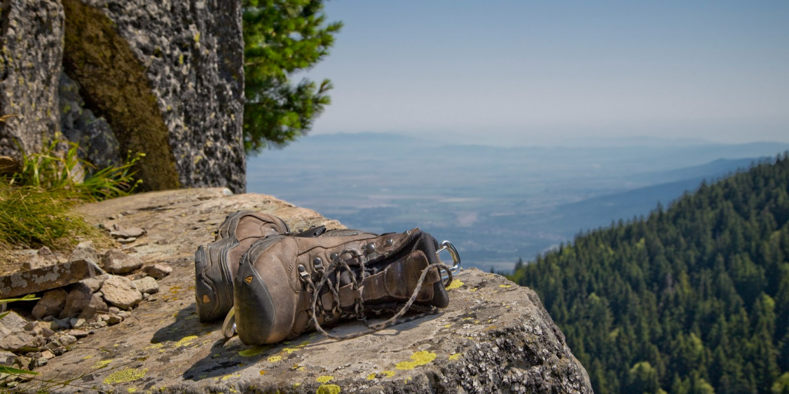 pair of brown leather boots on gray cliff