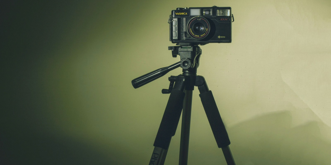 black and silver camera on tripod