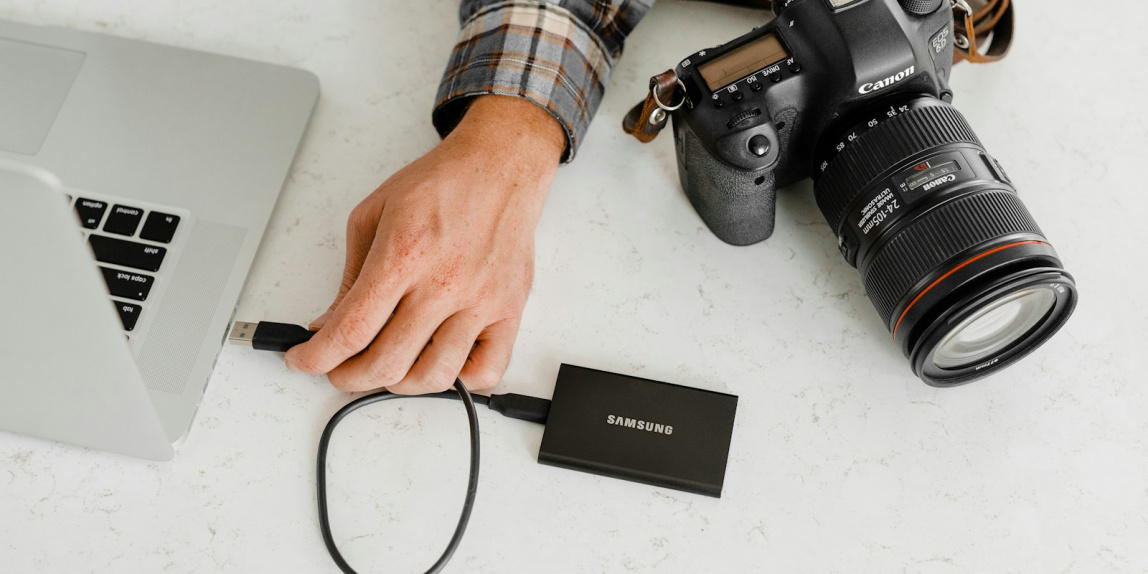 person holding black nikon dslr camera