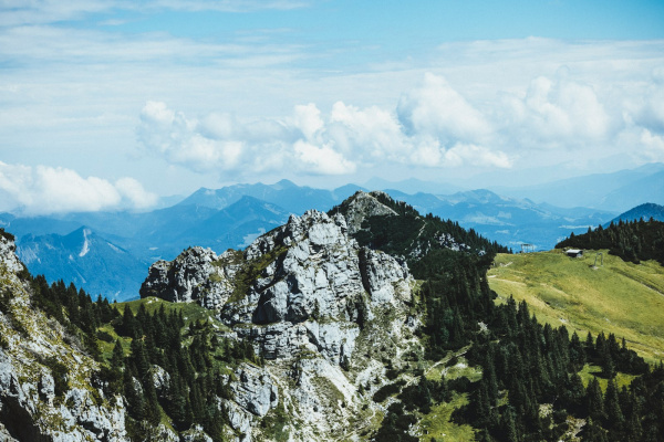 a view of a mountain range with trees and mountains in the background