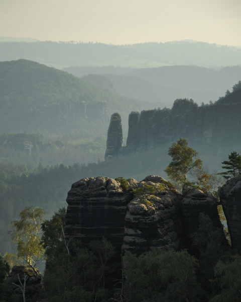 a view of a mountain range with rocks and trees