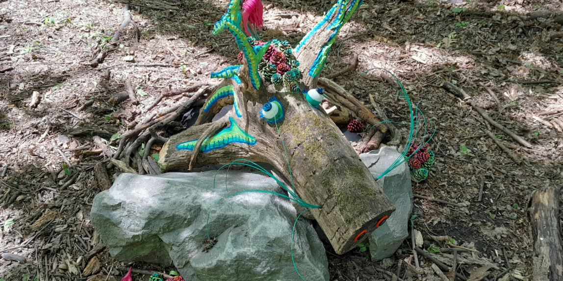 a statue of a bird sitting on top of a rock