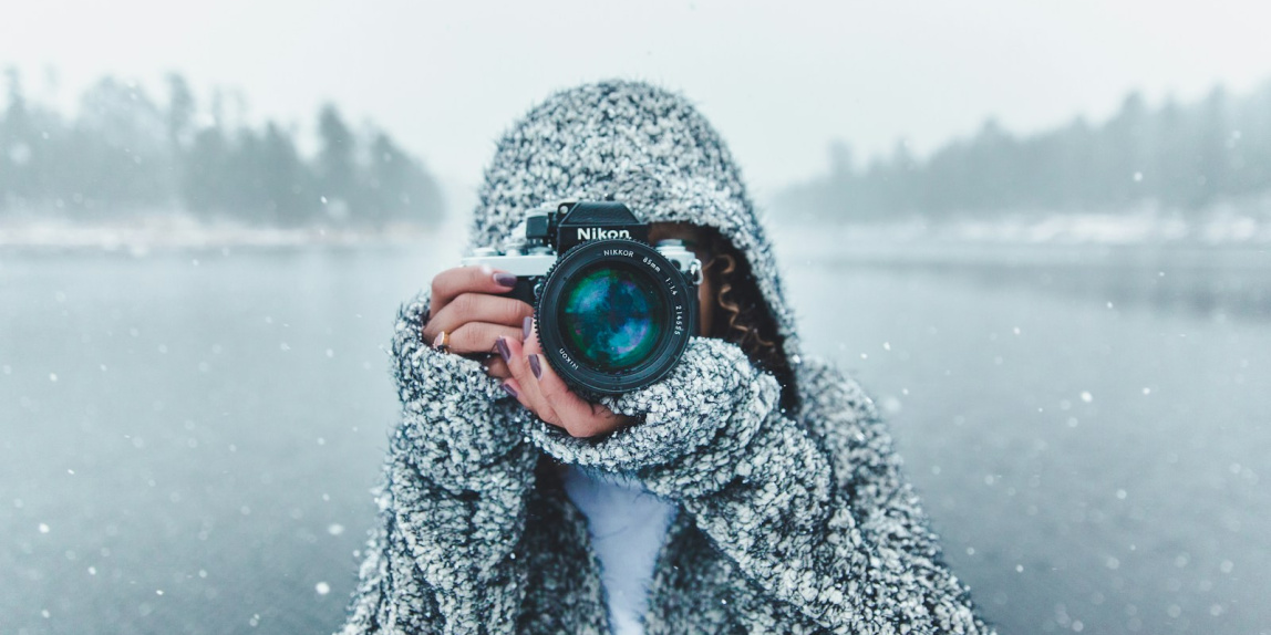 woman using Nikon DSLR camera