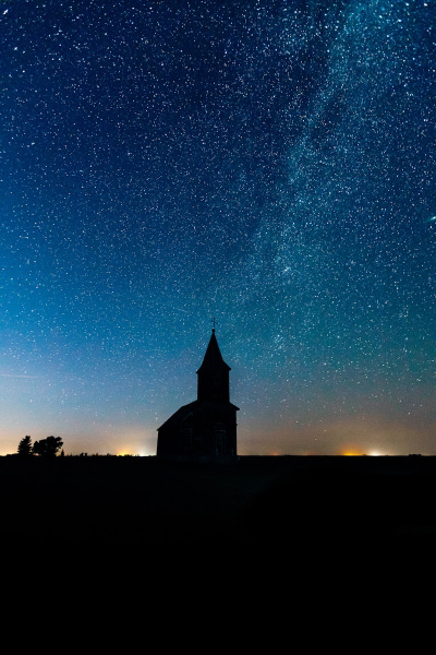 a building with a tower and stars in the sky