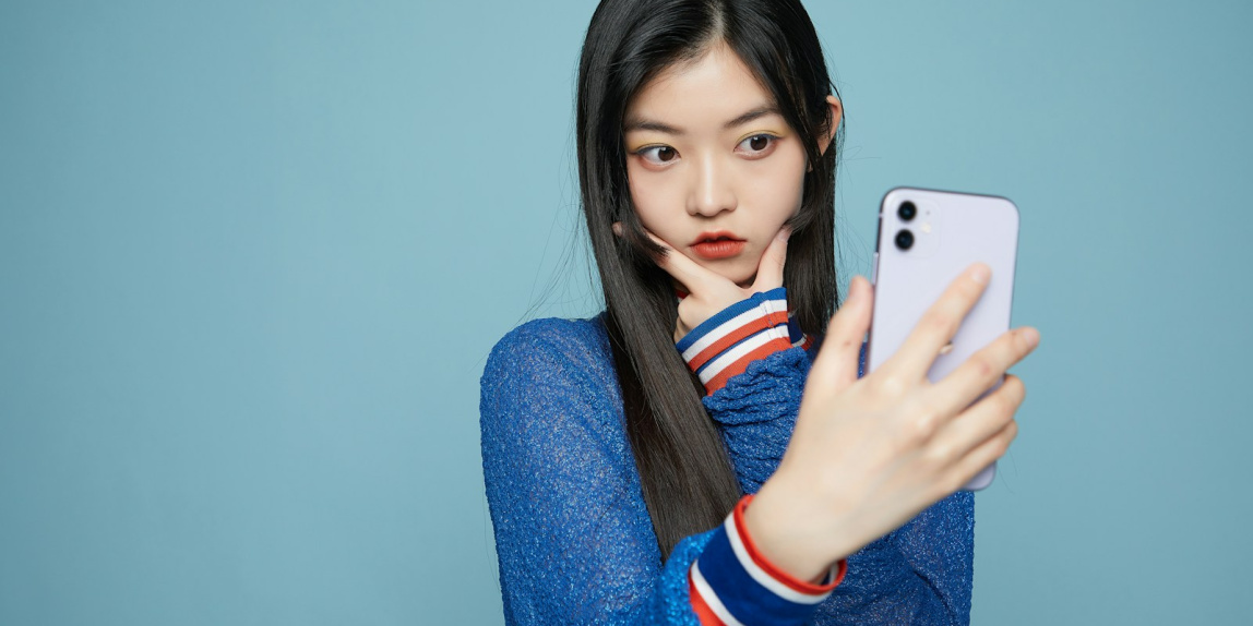 a woman taking a selfie with her cell phone