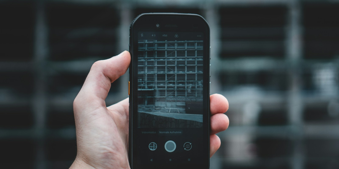 person holding black iphone 4