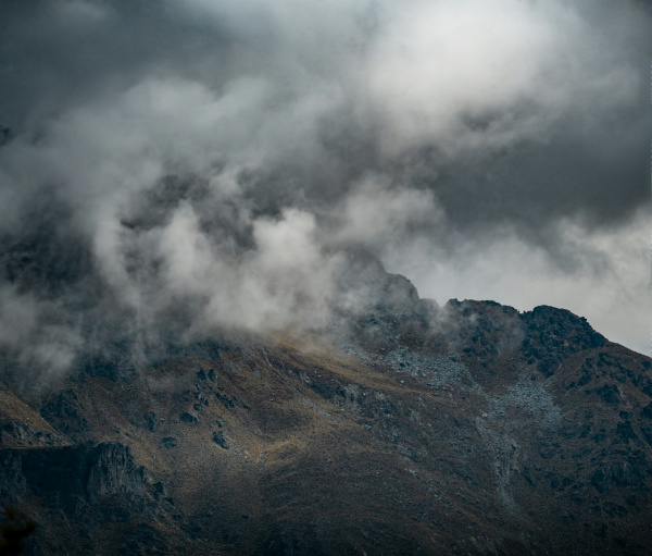 a mountain with clouds