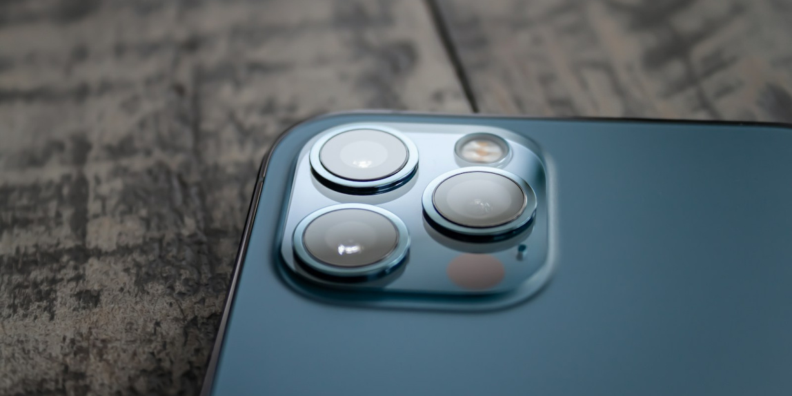 blue and white device on brown marble table