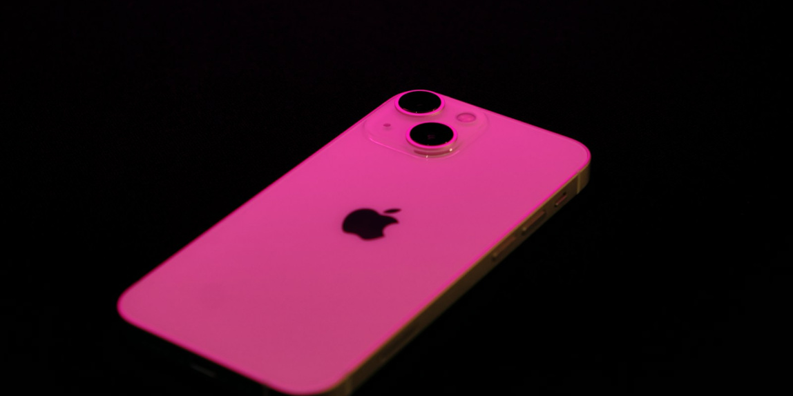 a pink iphone case sitting on top of a table