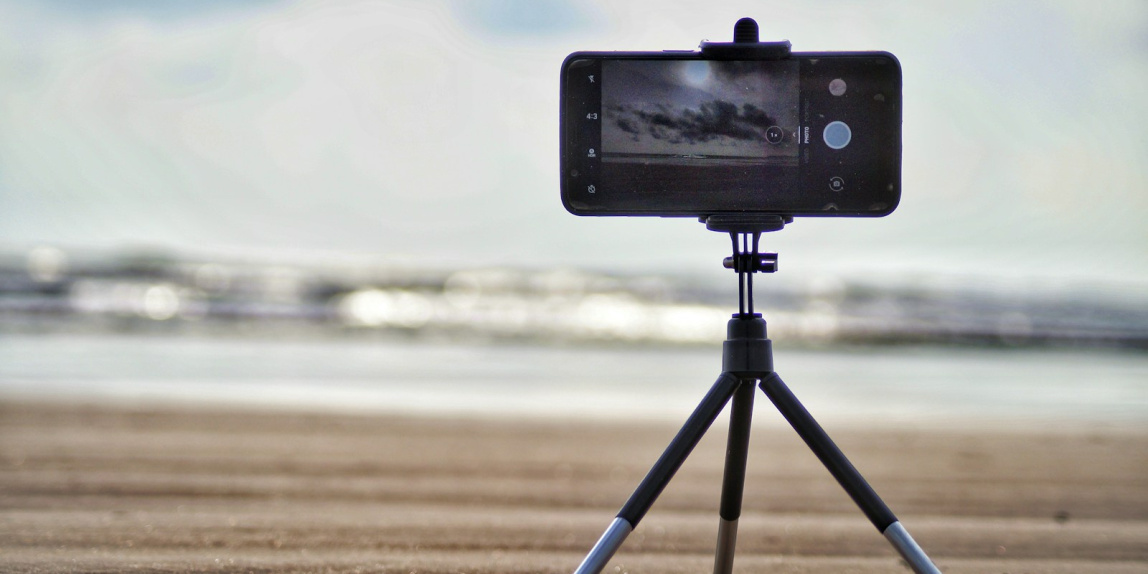 black smartphone near shore