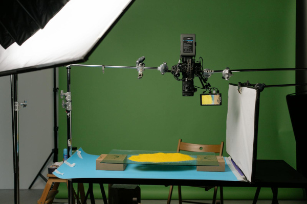 A detailed view of a professional photography studio setup, capturing products with precise lighting.