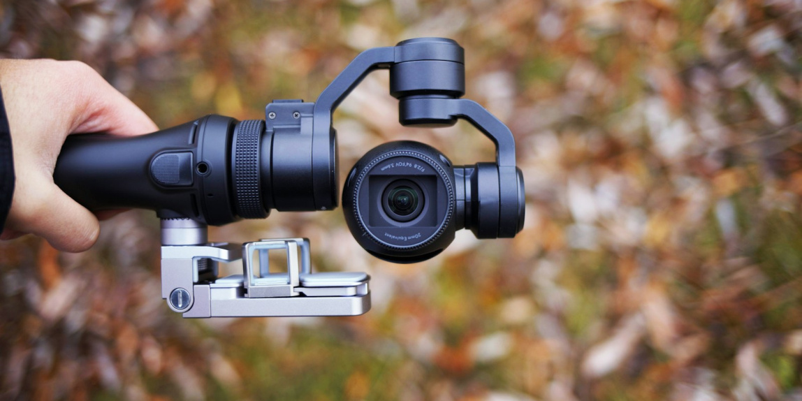 person holding black tripod with camera