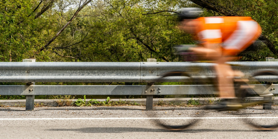 a person riding a bike on a road