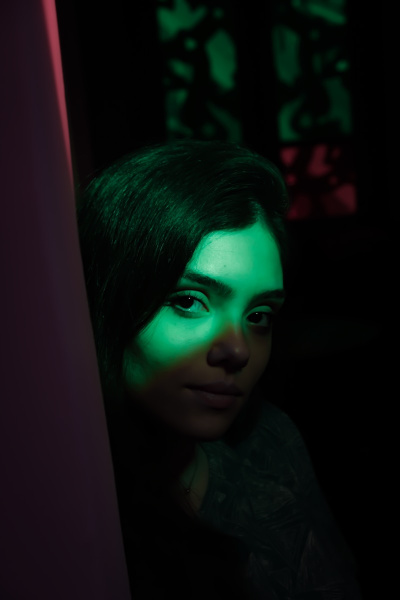 a woman with green light on her face