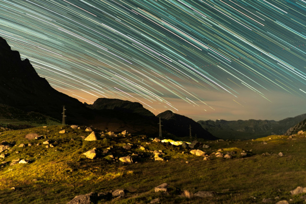 the night sky is filled with star trails