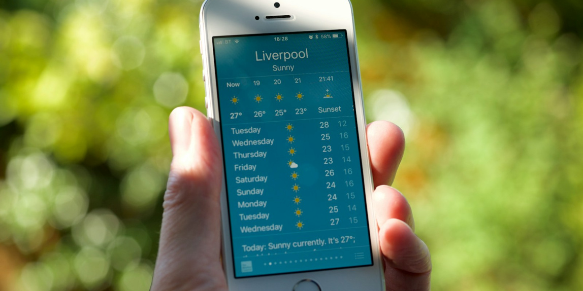 person holding turned on silver iPhone 5s displaying liverpool