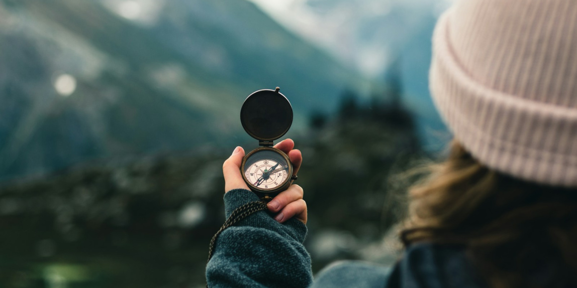 person holding black round container