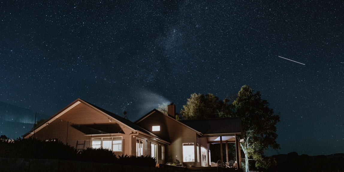 a house with a starry sky above it