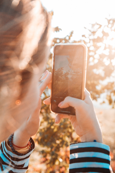 a person holding a cell phone up to their face